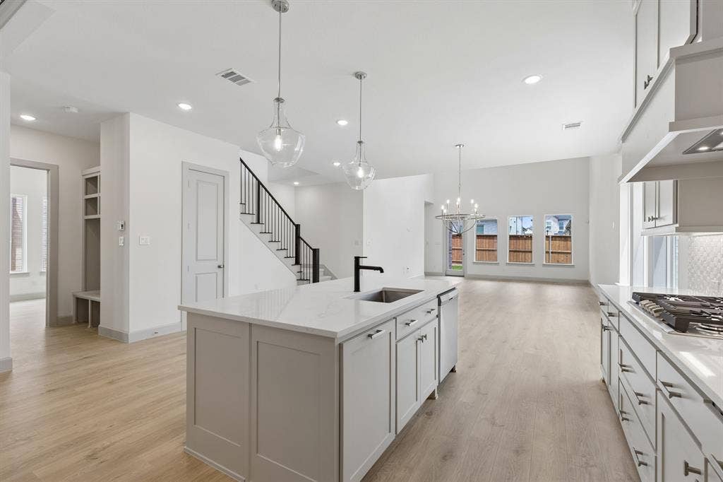 The spacious island sits center stage in this dream kitchen and offers the perfect place for friends and family to gather round!