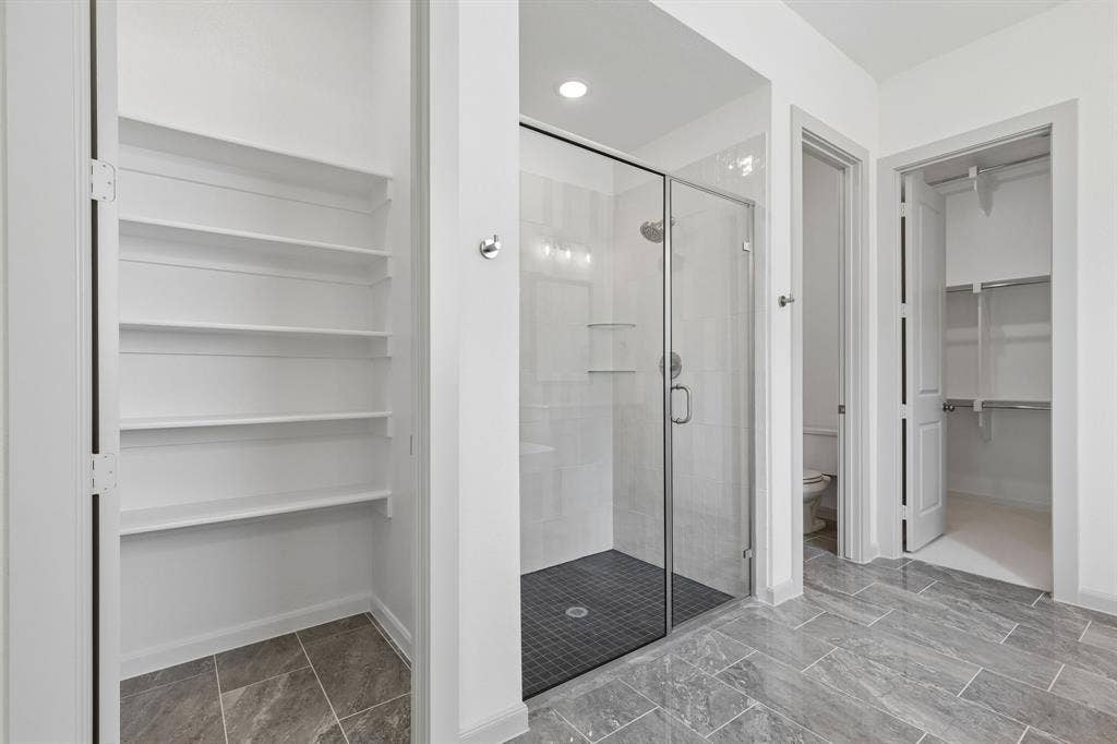 Featuring a wonderful walk in shower, linen closet and owner's closet with seasonal hanging space, this over the top owner's bath is a dream come true!