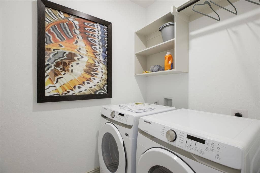 1456 Kit King Drive, Little Elm, TX 75036 Integrated laundry area featuring built-in shelving, a hanging rod, and white appliances