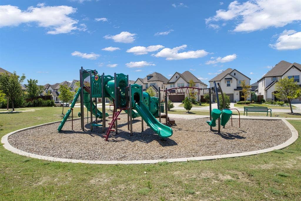 1456 Kit King Drive, Little Elm, TX 75036 Community playground featuring a multi-level play structure, slides, and swing sets