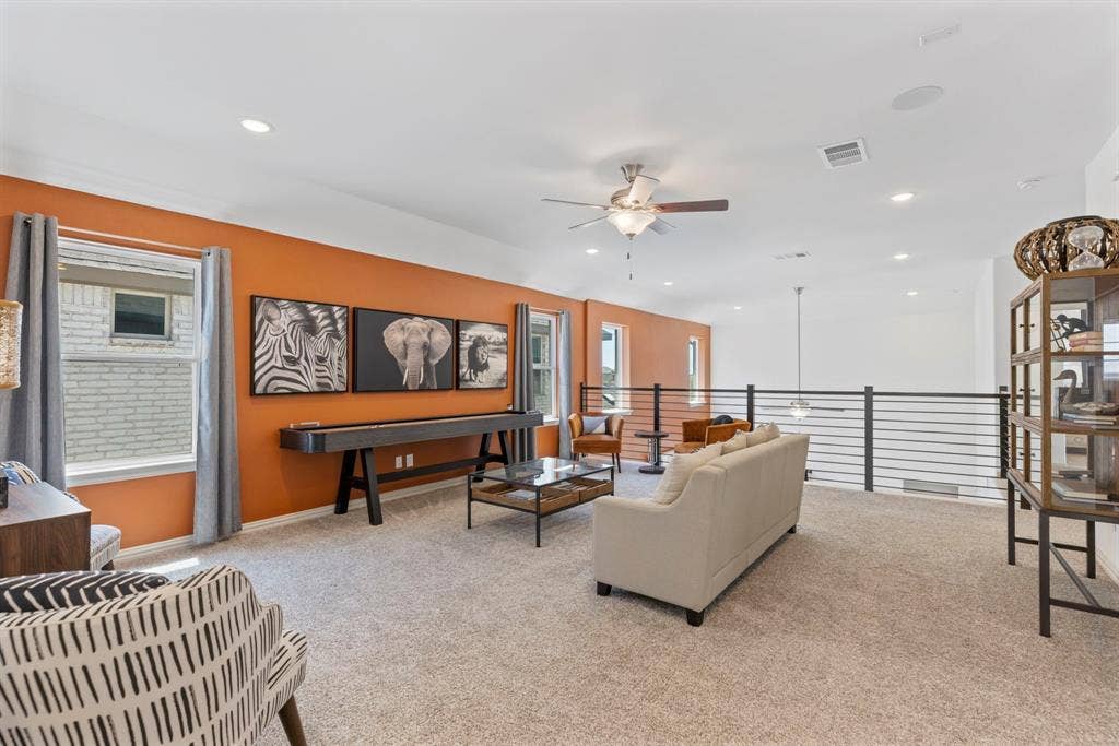 1456 Kit King Drive, Little Elm, TX 75036 Spacious loft area with carpeting, recessed lighting, ceiling fan, and horizontal metal railings