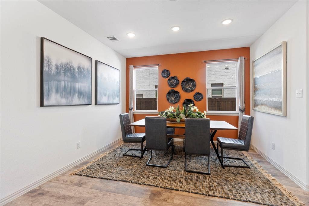 1456 Kit King Drive, Little Elm, TX 75036 Recessed lighting, warm accent wall, dual windows, wood-finish flooring, and white baseboards