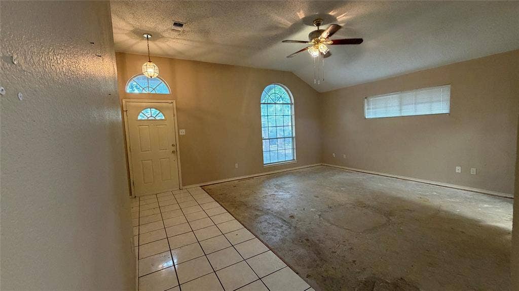 2718 High Pointe Boulevard, McKinney, TX 75071 Arched window and transom above the entry, vaulted ceiling, and ceiling fan