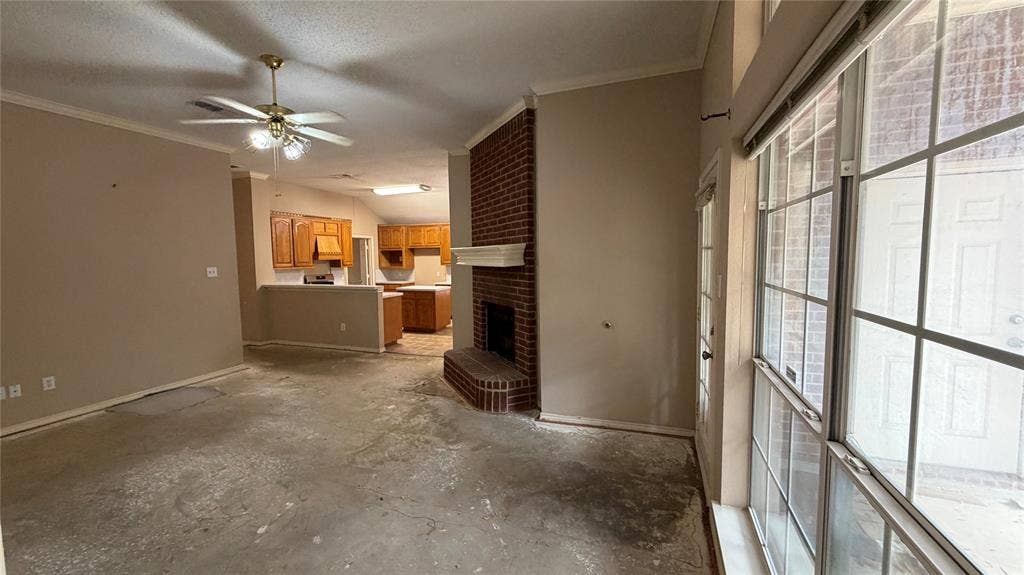 2718 High Pointe Boulevard, McKinney, TX 75071 Living area with exposed subfloor, brick fireplace with mantel, and ceiling fan