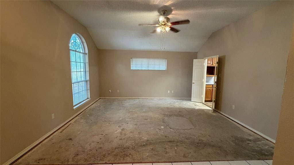 2718 High Pointe Boulevard, McKinney, TX 75071 Vaulted ceiling with ceiling fan, arched window, and additional rectangular window