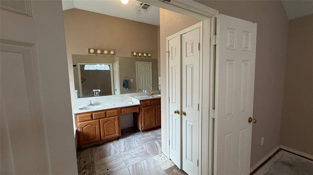 2718 High Pointe Boulevard, McKinney, TX 75071 Vaulted ceiling, dual vanity, wood-finish cabinetry, built-in makeup vanity, and tile flooring