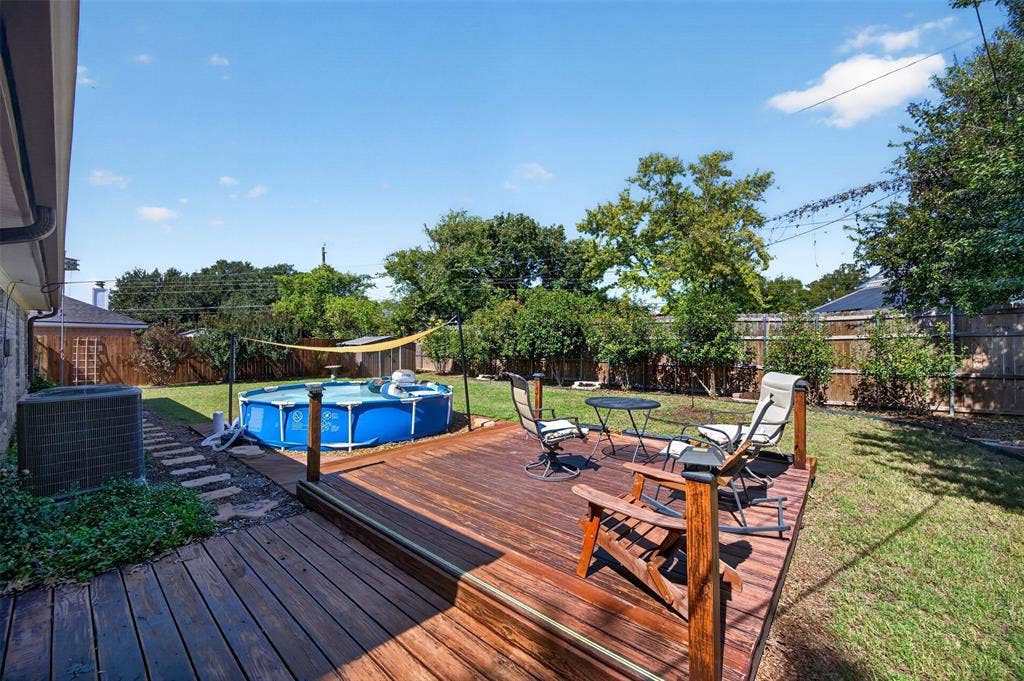 203 Briarglen Drive, Cedar Hill, TX 75104 Expansive backyard featuring a wood deck, manicured lawn, and privacy fencing