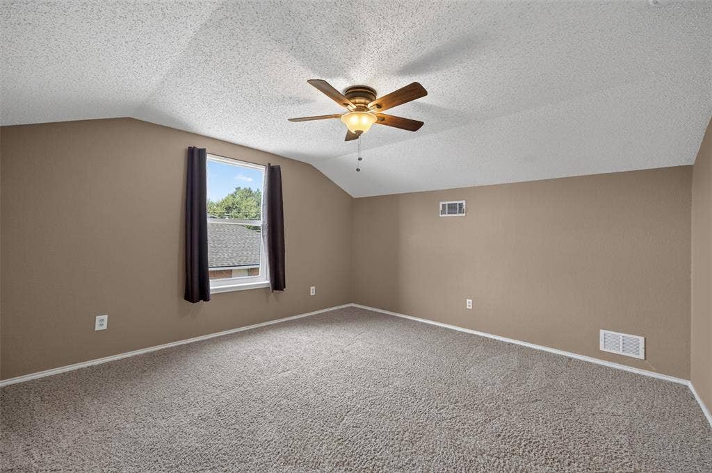 203 Briarglen Drive, Cedar Hill, TX 75104 Vaulted ceiling, ceiling fan with integrated lighting, carpeted flooring, and window with dark drapes