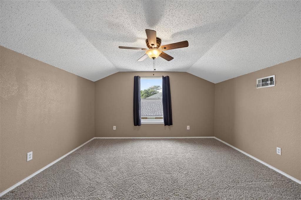 203 Briarglen Drive, Cedar Hill, TX 75104 Vaulted ceiling, ceiling fan, neutral wall tones, carpet flooring, window with exterior landscape