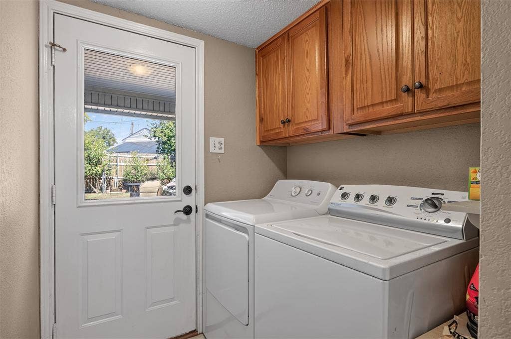 203 Briarglen Drive, Cedar Hill, TX 75104 Laundry area featuring wood cabinetry, white appliances, and a door with an upper glass panel