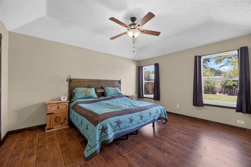 203 Briarglen Drive, Cedar Hill, TX 75104 Vaulted ceiling with a ceiling fan, two windows, and wood-finish flooring