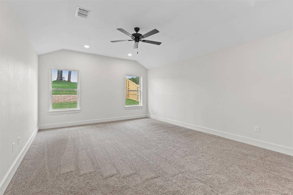 16514 Crossing Circle, Lindale, TX 75771 Vaulted ceiling with recessed lighting and a ceiling fan, plush carpet, and two windows