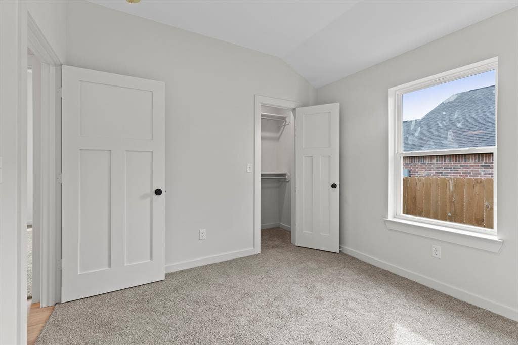16514 Crossing Circle, Lindale, TX 75771 Carpeted room with white walls, a single window, and a built-in closet with shelving and hanging rod