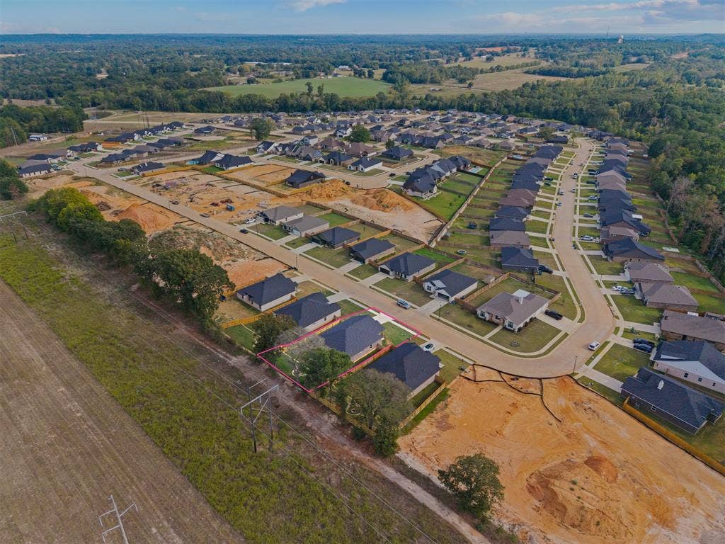 16514 Crossing Circle, Lindale, TX 75771 Residential development with established and developing homesites, paved streets, and abundant tree coverage in the surrounding landscape