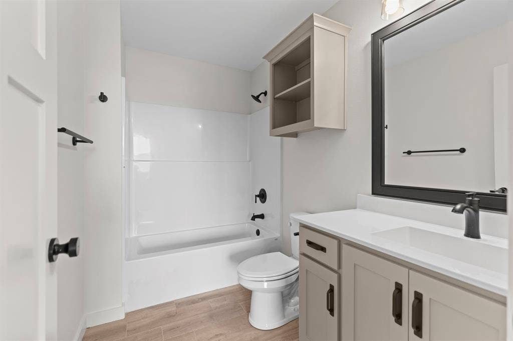 16514 Crossing Circle, Lindale, TX 75771 White-paneled bathtub and shower combination with matte black fixtures