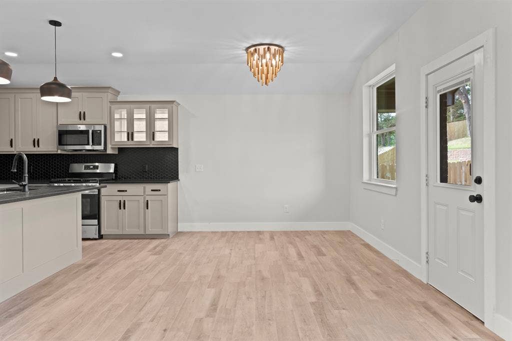 16514 Crossing Circle, Lindale, TX 75771 Kitchen and dining area featuring light-toned wood-finish flooring, recessed lighting, and a decorative ceiling fixture