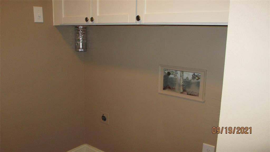 13433 Blossomheath Lane, Dallas, TX 75240 Washer and dryer area with built in cabinets