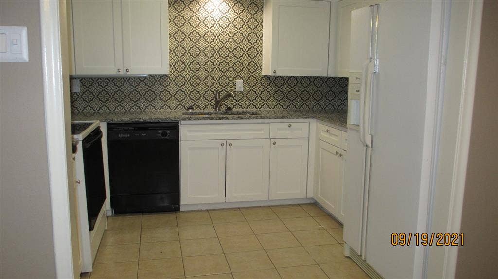 13433 Blossomheath Lane, Dallas, TX 75240 Kitchen with Maytag refrigerator designer backsplash