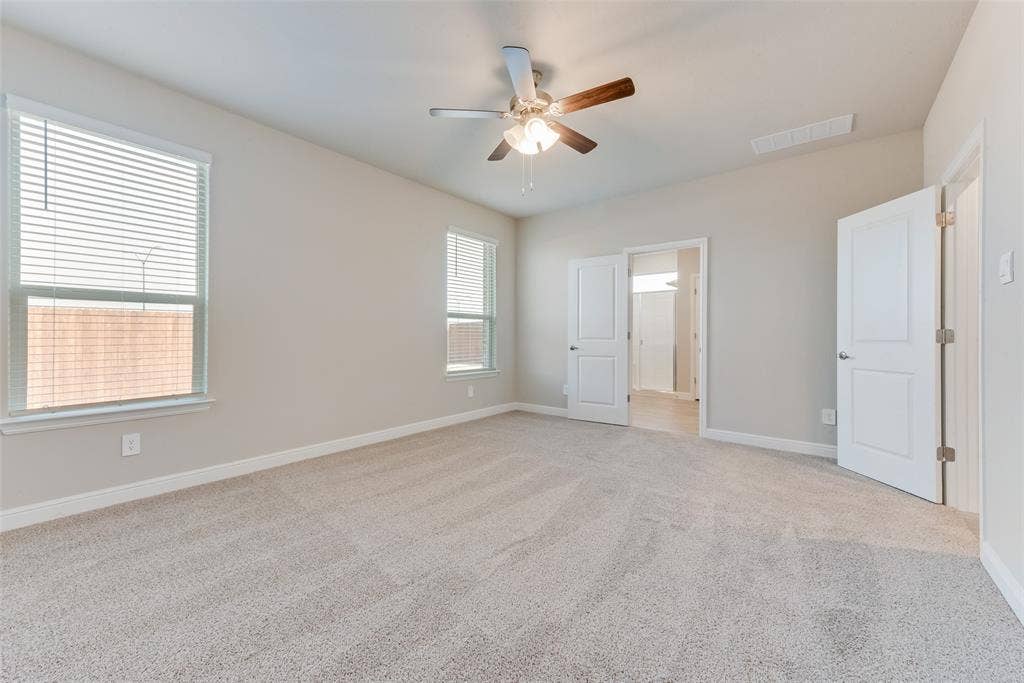 Unfurnished bedroom featuring light colored carpet and ceiling fan