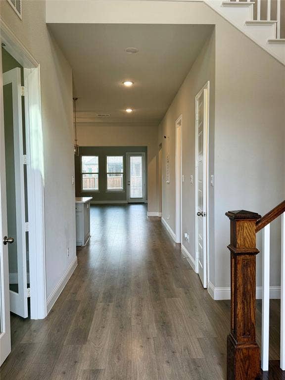1196 Putnam Drive, Frisco, TX 75036 Wood-finish flooring throughout, recessed lighting, and a wood newel post with white balusters