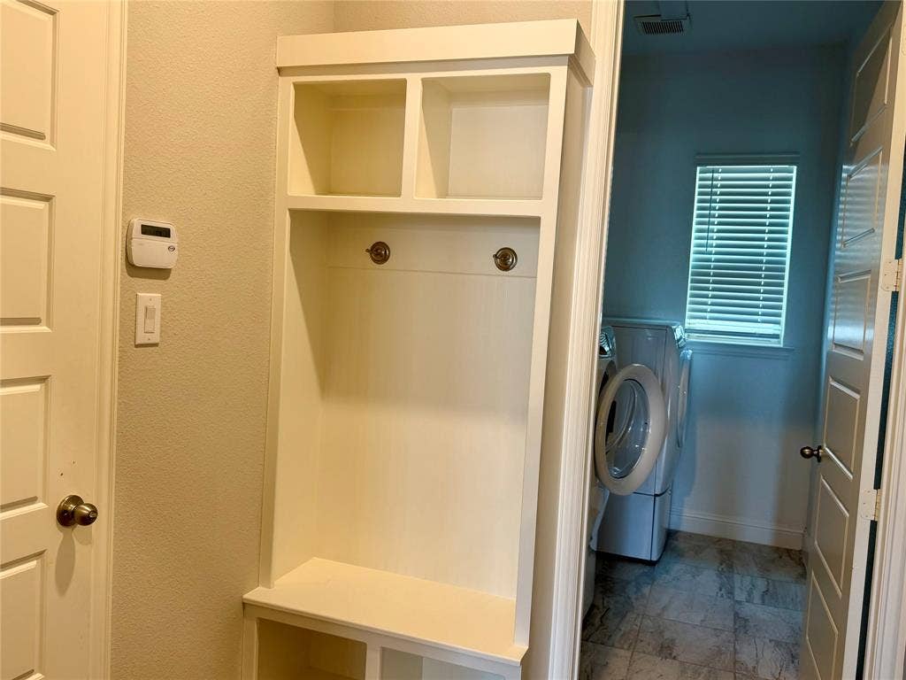 1196 Putnam Drive, Frisco, TX 75036 Built-in white storage unit with cubbies and coat hooks