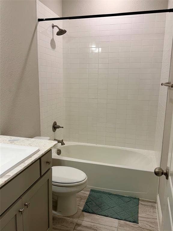 1196 Putnam Drive, Frisco, TX 75036 Bathroom featuring a white subway tile shower surround, a white bathtub, and a single vanity with a light-colored countertop