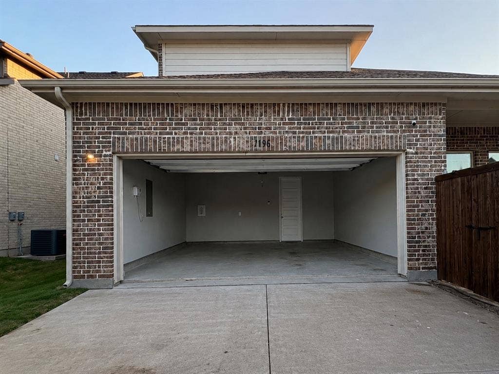 1196 Putnam Drive, Frisco, TX 75036 Attached two-car garage with a concrete driveway