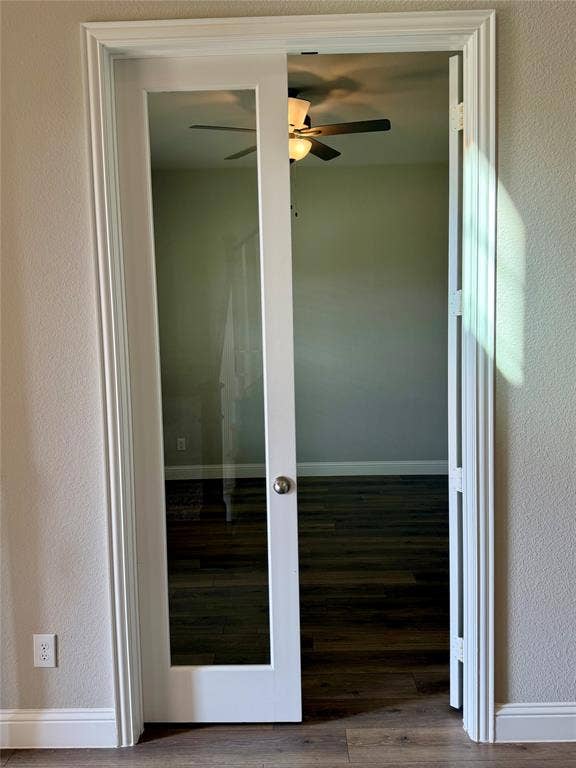 1196 Putnam Drive, Frisco, TX 75036 Study with double French doors with clear glass panels, wood-finish flooring, and a ceiling fan with integrated lighting to the left of entry