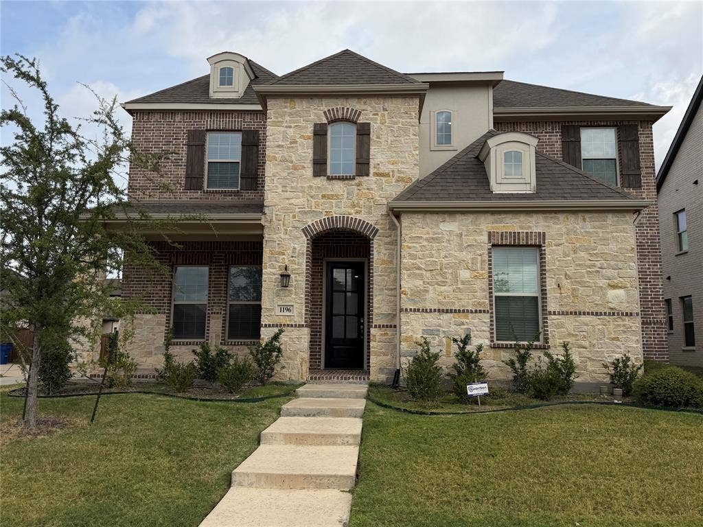 1196 Putnam Drive, Frisco, TX 75036 Stone and brick facade with dark wood shutters
