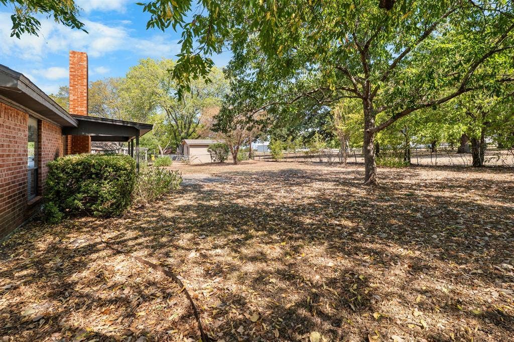 544 Jason Street, Robinson, TX 76706 Expansive yard with mature trees, brick exterior, and covered patio