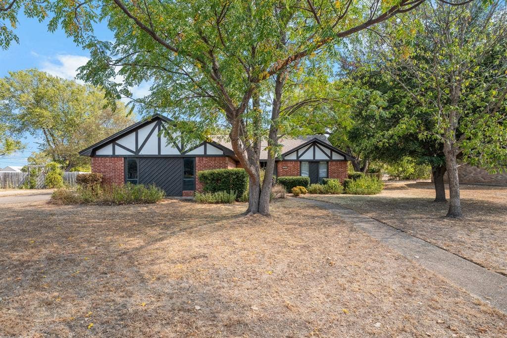 544 Jason Street, Robinson, TX 76706 Brick exterior with white and dark trim, gabled roofline, and established trees