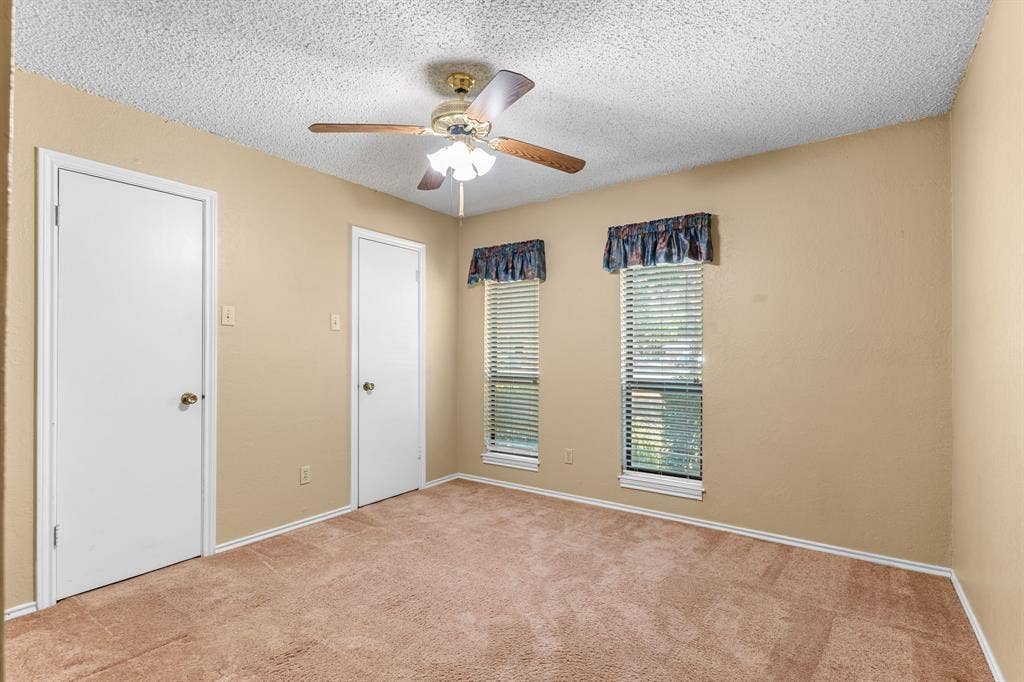 544 Jason Street, Robinson, TX 76706 Carpeted flooring, ceiling fan with integrated lighting, two windows with blinds, and multiple doors