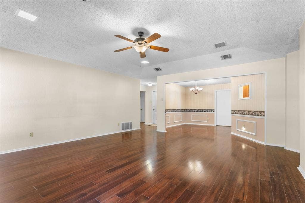 544 Jason Street, Robinson, TX 76706 Wood-finish flooring throughout, ceiling fan with integrated lighting, recessed lighting, and an archway opening to an additional room with decorative wall paneling
