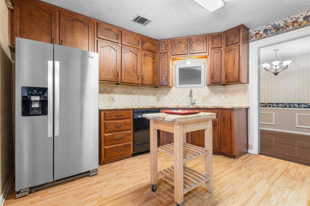 544 Jason Street, Robinson, TX 76706 Wood-finish flooring with full-height cabinetry, solid surface countertops, and an undermount sink