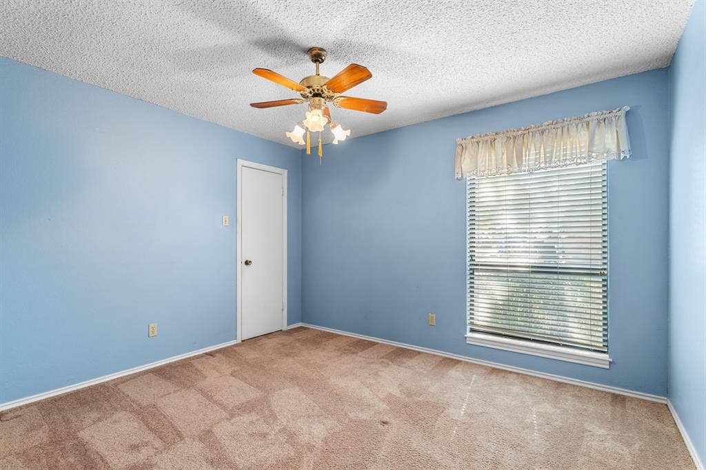 544 Jason Street, Robinson, TX 76706 Ceiling fan with integrated lighting, window with blinds, light blue painted walls, wall-to-wall carpeting, and white trim