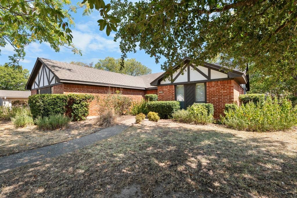 544 Jason Street, Robinson, TX 76706 Brick exterior featuring white and dark trim, gabled roofline, and established shrubbery