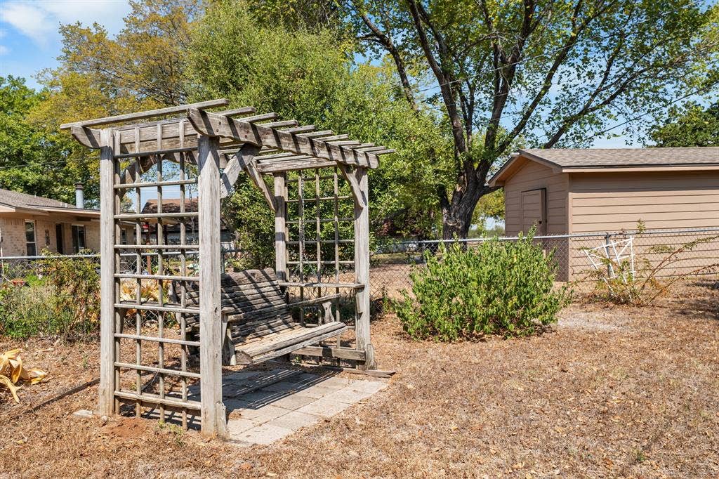 544 Jason Street, Robinson, TX 76706 Wood pergola with integrated swing bench, paver base, and rear storage shed
