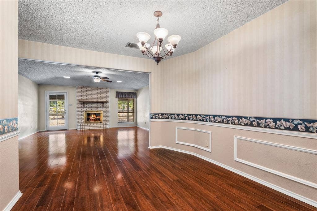 544 Jason Street, Robinson, TX 76706 Hardwood-style flooring throughout, with a brick fireplace and mantel