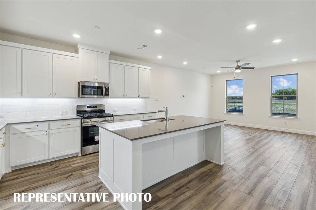 4733 Lunker Street, McKinney, TX 75071 The spacious island offers the perfect place for friends and family to gather round! REPRESENTATIVE PHOTO