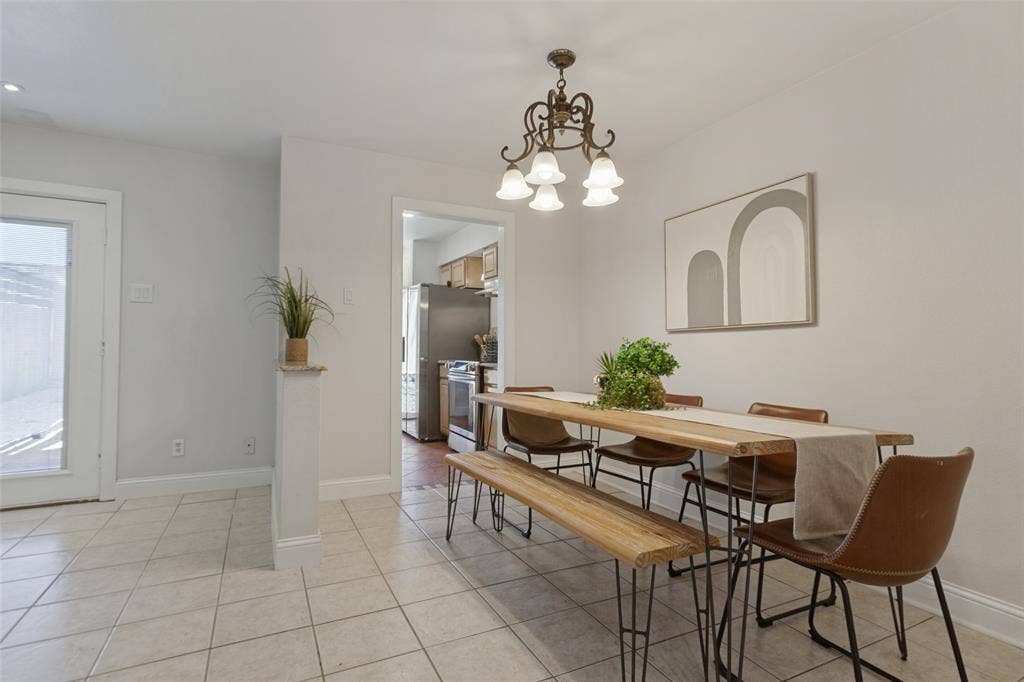 351 Valley Park Drive, Garland, TX 75043 351 Vally Park Dr. - Dining area featuring newer tile flooring and a stylish chandelier, creating a bright and inviting space for everyday meals or entertaining.