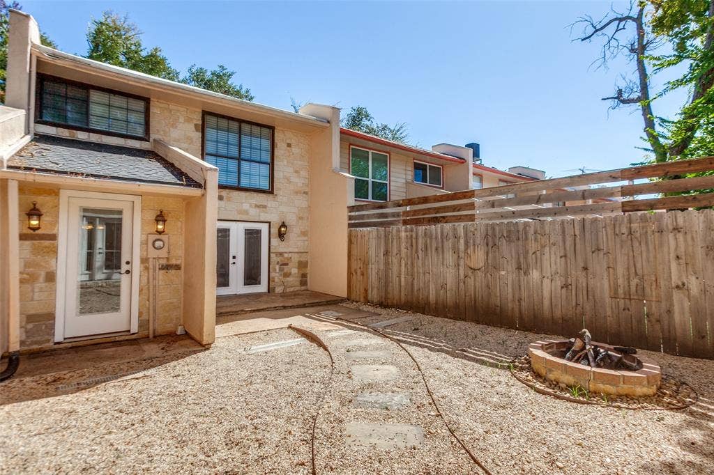 351 Valley Park Drive, Garland, TX 75043 351 Vally Park Dr. - Back of home featuring a low-maintenance backyard with a fire pit, perfect for relaxing or entertaining outdoors.