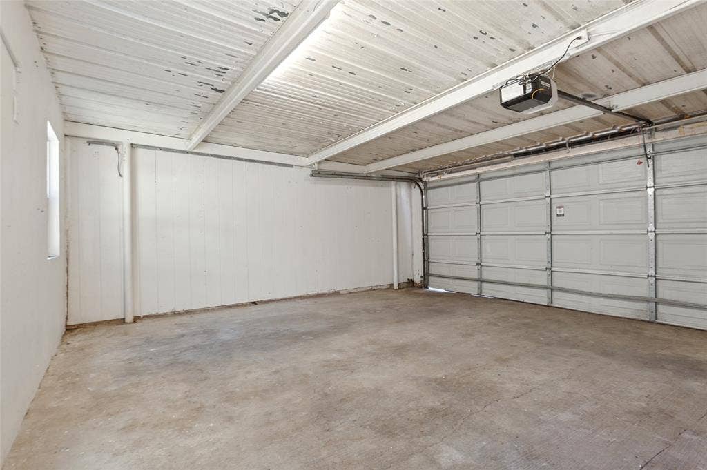 351 Valley Park Drive, Garland, TX 75043 351 Vally Park Dr. - Detached garage featuring a newer garage door and opener, providing convenient parking and additional storage space.