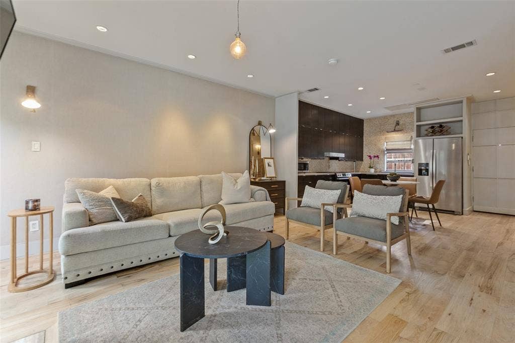 3818 N Hall Street, #128, Dallas, TX 75219 Open floor plan with light wood floors downstairs