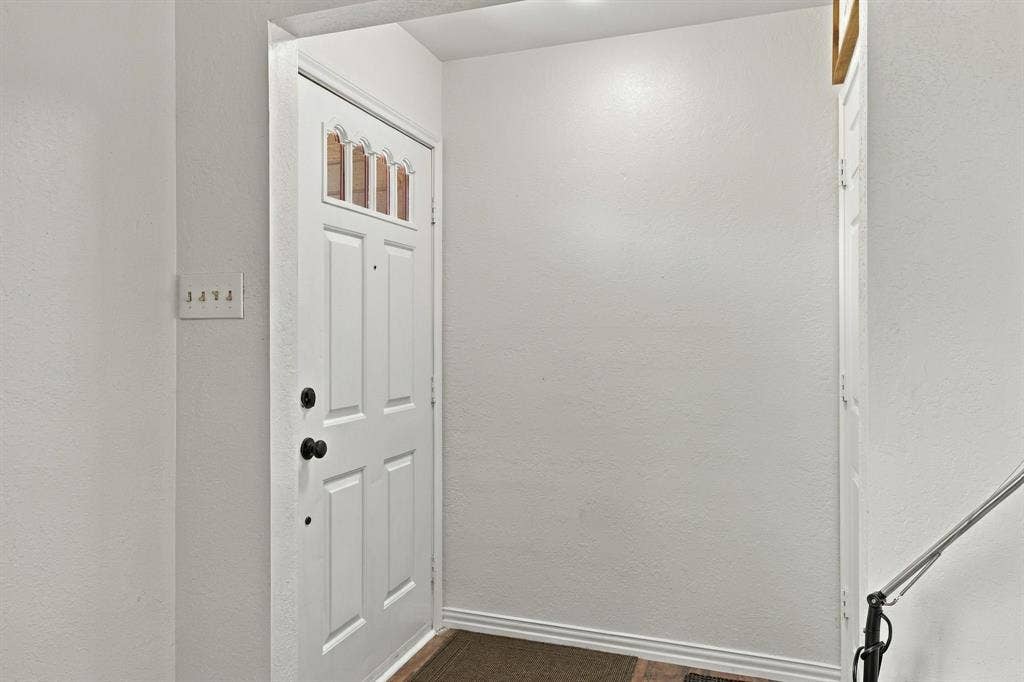1015 Shelly Drive, Keene, TX 76031 White paneled door with decorative glass inserts and black hardware