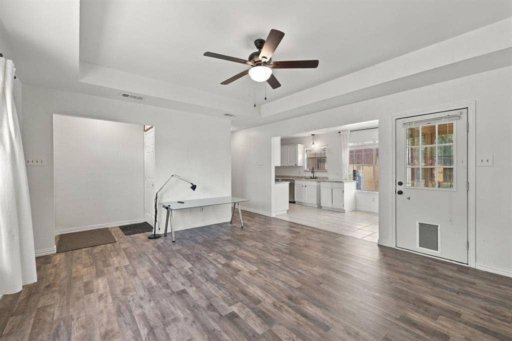 1015 Shelly Drive, Keene, TX 76031 Wood-finish flooring throughout, tray ceiling, and ceiling fan