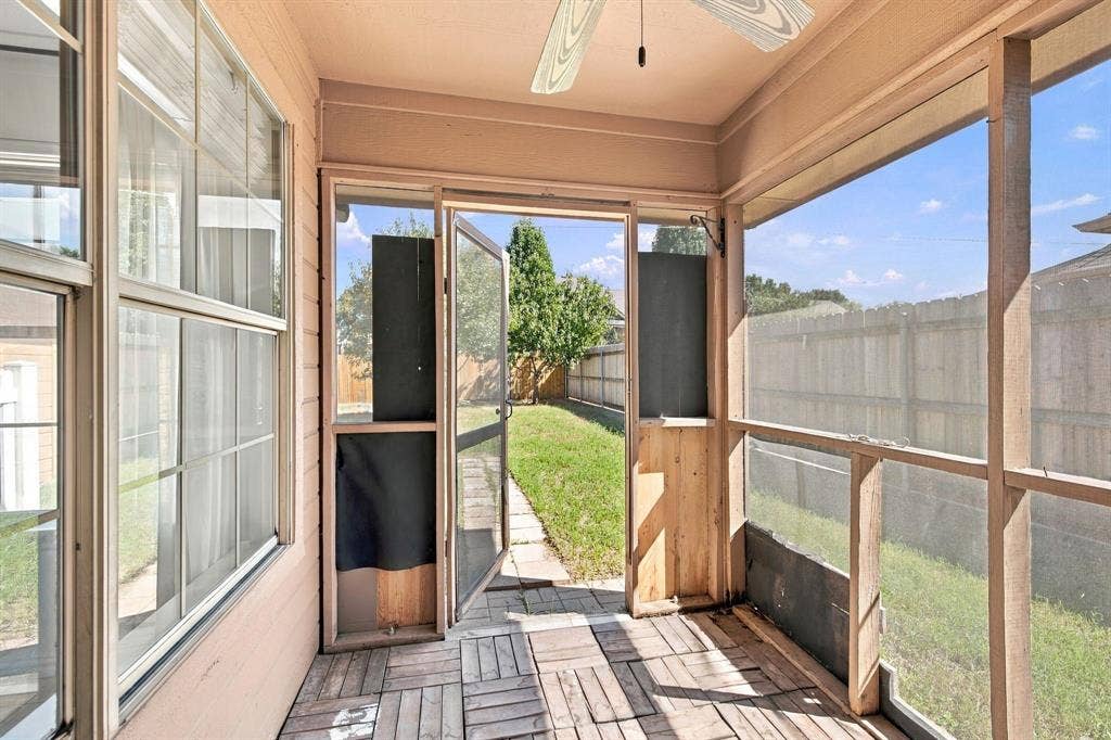 1015 Shelly Drive, Keene, TX 76031 Screened porch featuring a ceiling fan, plank-style flooring, and direct access to a fenced yard