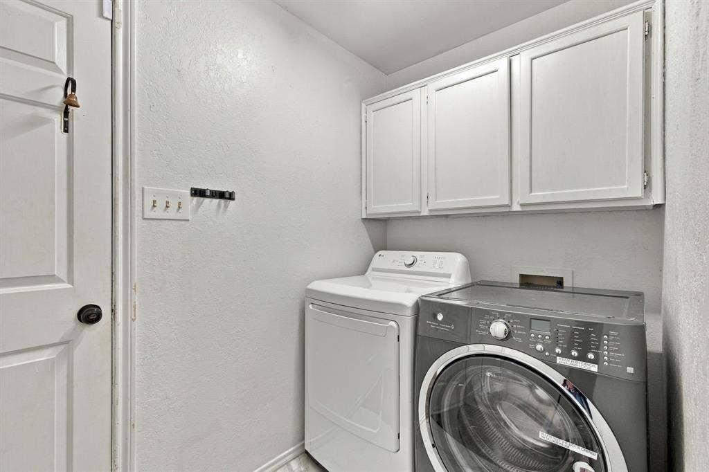 1015 Shelly Drive, Keene, TX 76031 Wall-mounted cabinetry providing storage