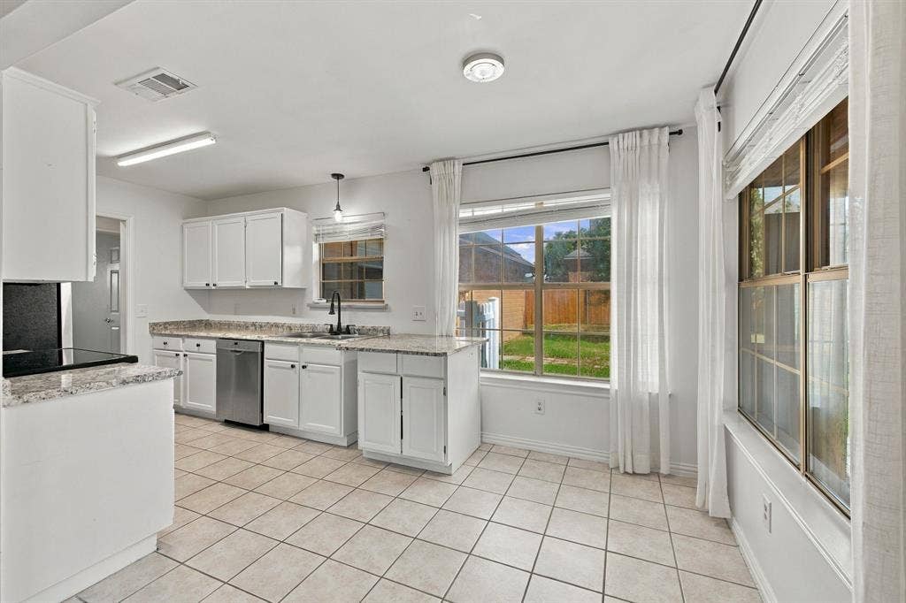 1015 Shelly Drive, Keene, TX 76031 Kitchen featuring white cabinetry, light-toned countertops, a stainless steel dishwasher, a black cooktop, and tile flooring