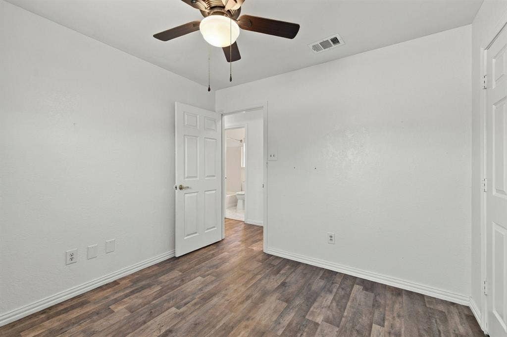 1015 Shelly Drive, Keene, TX 76031 Wood-finish flooring, white walls, and a ceiling fan with integrated lighting