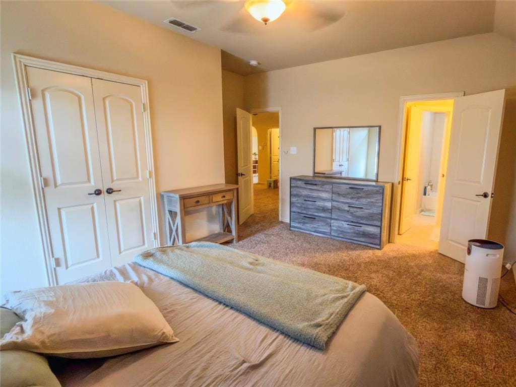 Carpeted flooring throughout, double-door closet, vaulted ceiling, and recessed lighting